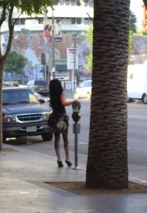 A woman stands on a street corner