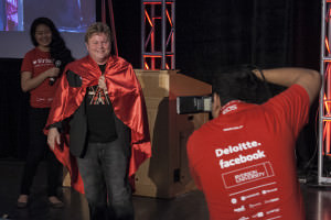 Bob Richards was awarded a red cape for his contributions to the conference. All speakers received super hero capes at CUTC Infect 2013. Image courtesy of Ani Hajderaj