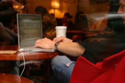 Man seated in cafe with laptop